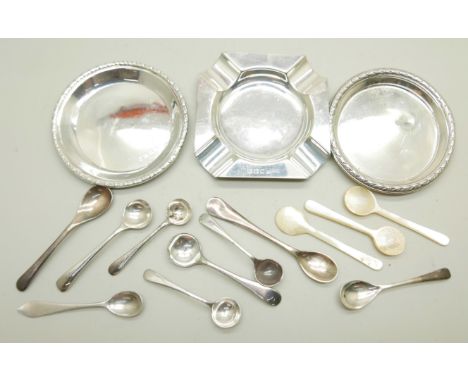 A silver ash tray, two silver dishes, and a collection of salt spoons including mother of pearl examples and two silver plate