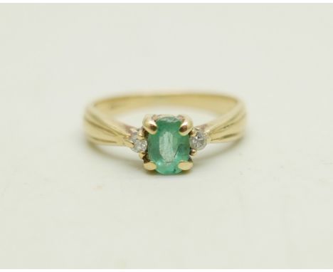 A 9ct gold ring set with an emerald and two small diamonds, 1.9g, J/K 