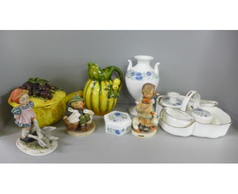 Two Hummel figures, a Wedgewood Clementine dressing table set comprising of a vase, two candle holders, two lidded boxes and 