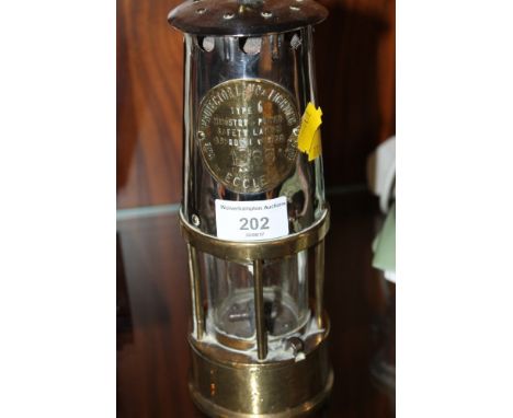 A BRASS MINER LAMP 'THE PROTECTOR LAMP AND LIGHTING COMPANY'