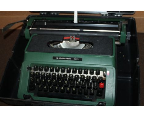 A SILVER REED TYPEWRITER, TOGETHER WITH A REEL TO REEL PLAYER AND SCREEN.