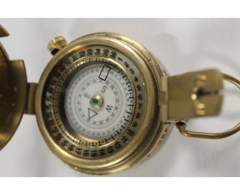 A BRASS MARCHING COMPASS 