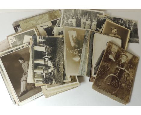 A quantity of loose photographic postcards of family groups, individuals and other portrait cards; studio portraits and group
