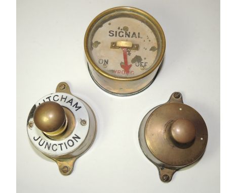 A signal box plunger, brass with enamelled ring "Mitcham Junction"; another brass plunger and a brass cased signal repeater (