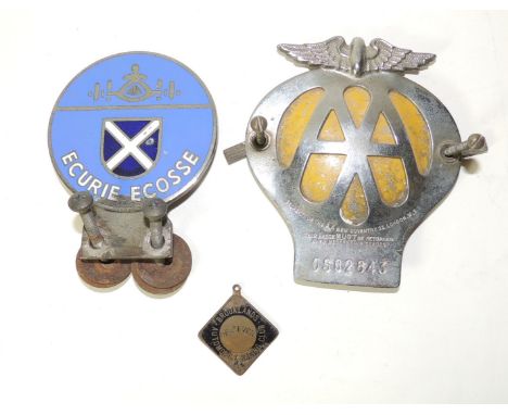 A Ecurie Ecosse enamelled white metal car badge; an AA members car badge no. OS62643 and a scarce enamelled metal Brooklands 