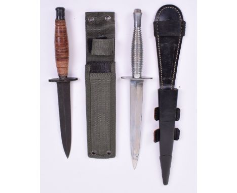 British Military Issue Commando Knife, being a modern example housed in its black leather sheath, one piece ribbed grip, blad