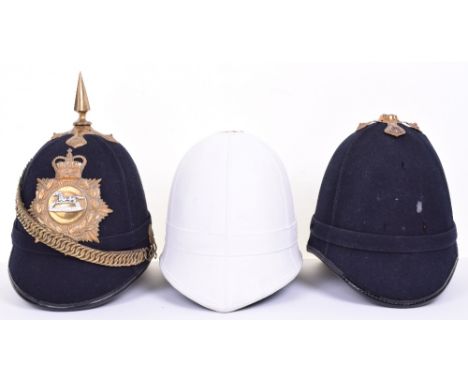 British Army Bandsman Home Service Helmets, blue cloth covered cork bodied helmet with brass fittings, brass helmet plate wit