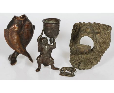 Comprising a lion's head with opening mouth, a candlestick in the shape of two fish, a small cachepot carried by an Asian fig