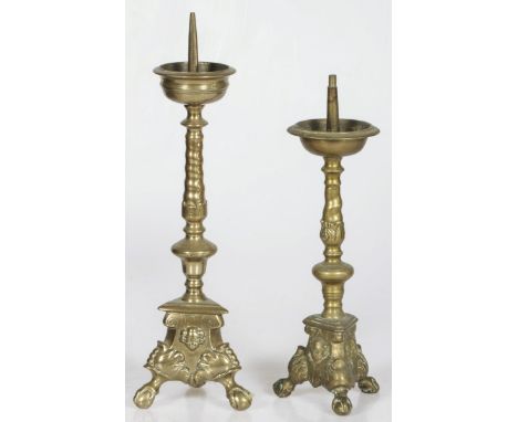 With cherubs and resting on claw-and-ball feet. The pricket of one candlestick is missing.H. ca. 48 and 41 cm. Estimate: € 40