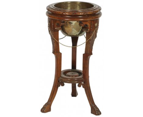 Together with a side table. The plant stand with carvings and decorative fittings resting on a tripod ending in carved claw f