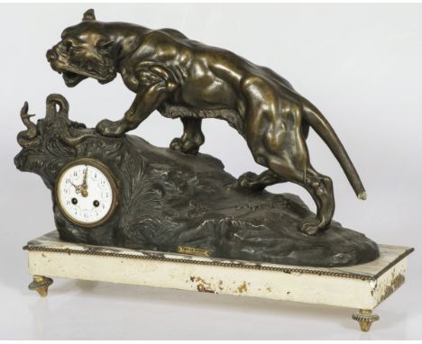 Sculpture of a tiger fighting a snake placed on a marble base. Signed 'RVarnier'. The pendulum and a foot underneath the base