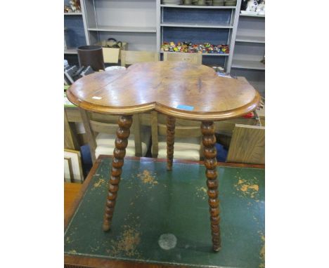 An early 20th century walnut finished occasional table having a three leaf clover design and bobbin turned legs, 24" h x 22 1