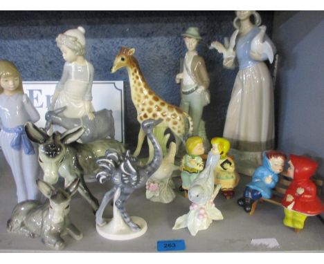 A Dutch Jema model of a giraffe, a pair of vintage cruet sets in the form of figures kissing on a park bench, a Lladro style 