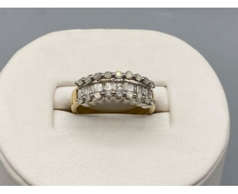 Ladies 18ct Yellow Gold Diamond Band, featuring baguette Diamonds in the centre with 9 round brilliant cut diamonds set each 