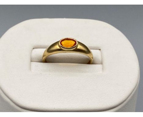 Ladies 9ct Yellow Gold fire opal ring, comprising of a oval stone set in a rubover setting, size N weighs 1.5g gross