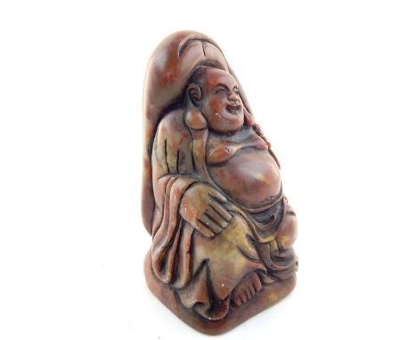 Chinese soapstone seal carved as a seated Buddha holding a sack over his head, inscription to verso, 12cm h