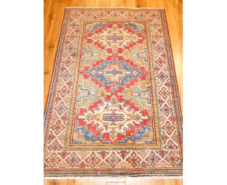 Caucasian rug, three cross medallions within green and red frame, medallion border, 180 x 106cm