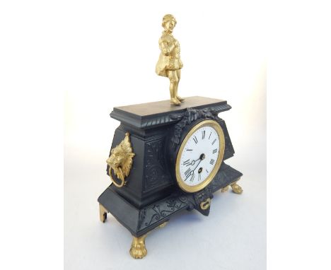 French cast metal mantel timepiece, parcel gilt, with gentleman in Tudor dress to finial, above white enamel dial with Roman 