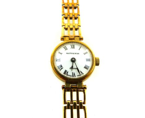 A ladies wristwatch retailed by Mappin & Webb, the white dial set out with Roman numerals, with a 9ct gold case and gate link