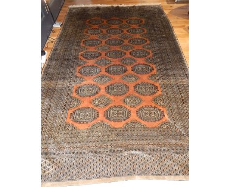 Bokhara rug, octagonal medallion to centre on rusty coloured ground, reticulated borders, fringed, 320 x 190cm