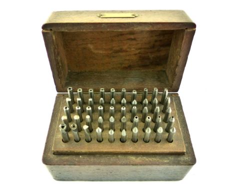 Boxed set of watchmaker's tools, a variety of fifty bushing and mounting implements