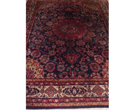 Persian indigo ground Moud carpet, central flower head medallion, within floral spandrels, 317 x 220cm