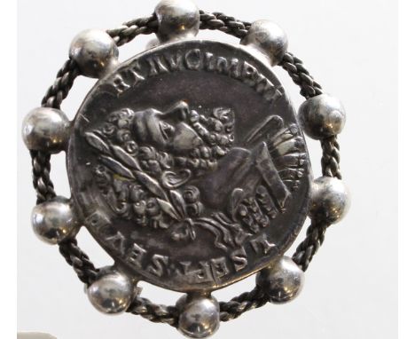 An ornate silver mounted brooch of c.40mm., depicting the Roman Emperor Septimius Severus [193-211 A.D.] and taken from a bra