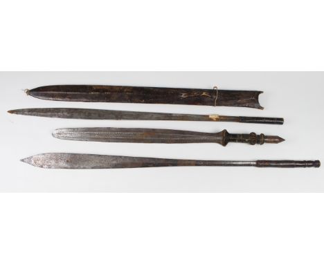 African swords: 1) A good Maasai Seme tribesman's sword in its leather scabbard. Blade 29". Of some age probably 19th century