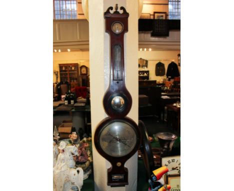 A 19th century mahogany cased wheel barometer with thermometer, humidity and spirit level dials