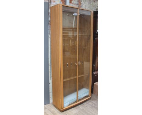 An Ercol blonde elm glazed display cabinet bookcase, width 92cm, depth 31cm &amp; height 214cm.  