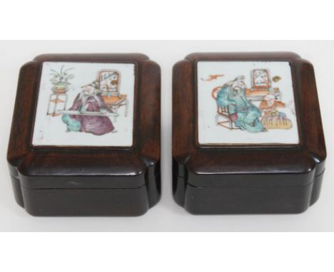 A pair of Chinese porcelain hardwood boxes, each top inset with porcelain panel, width 13cm, depth 14.5cm &amp; height 8cm.  