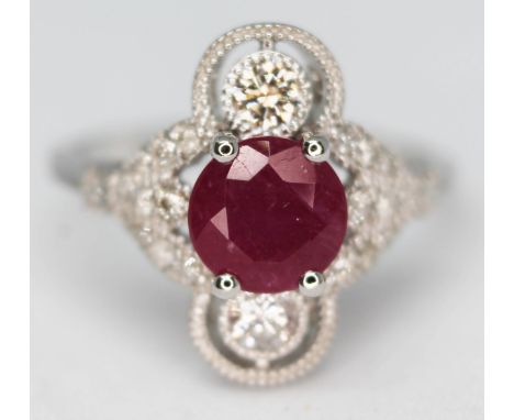 An 18ct white gold ruby and diamond cluster ring featuring a round brilliant cut ruby approx. 0.98ct, marked '750', gross wt.