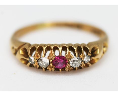 A hallmarked 18ct gold ring set with diamonds and a ruby coloured stone, gross wt. 1.9g, size J.  