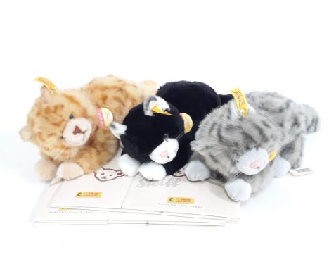 A group of three Steiff cats with ear tags, labels and boxes. 