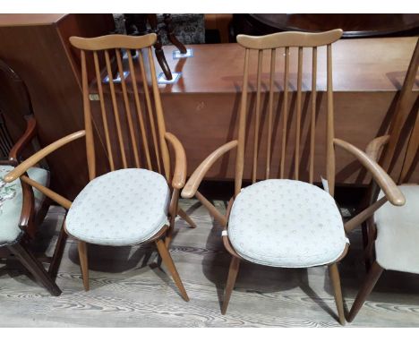 A pair of Ercol blonde spindle back armchairs.  