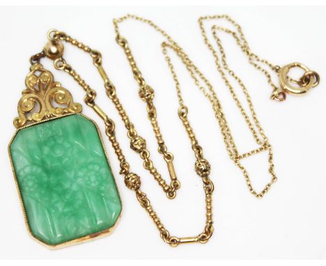 A yellow metal mounted carved jade pendant on chain, pendant length 40mm, chain length 42cm, clasp indistinctly marked, gross