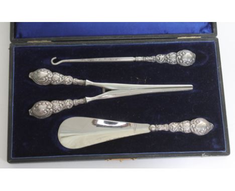 A cased set of hallmarked silver handled glove stretchers, button hook and shoe horn.  