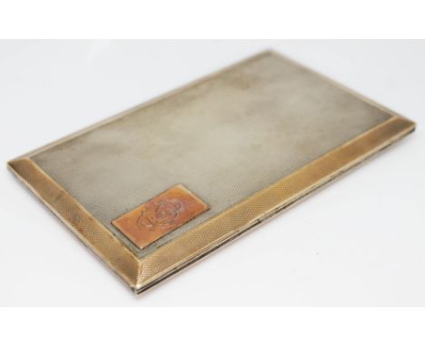 An Art Deco hallmarked silver cigarette case by Asprey, slide open with yellow metal cartouche to front and gilt interior, 8c