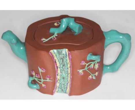 A Chinese Yixing red clay teapot, seal mark to base, length 19cm.  Condition - chip to inside of lid, minor losses to applied