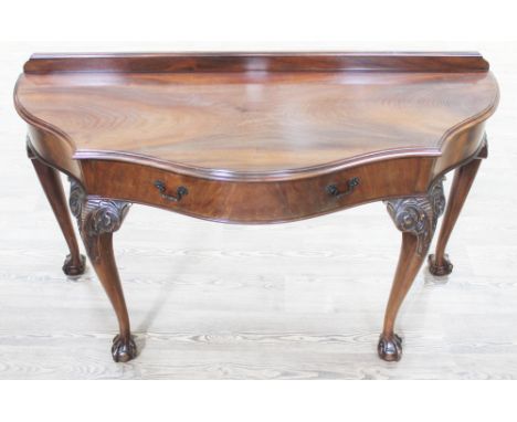 A Georgian style mahogany console table, early 20th century, with single drawer, cabriole legs with carved knees, claw and ba