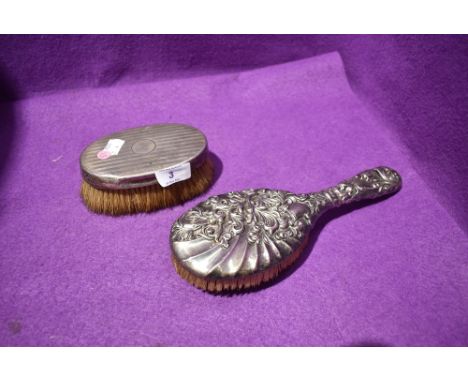 An HM silver backed clothes brush having engine turned stripe decoration and plain cartouche and an HM silver backed hair bru