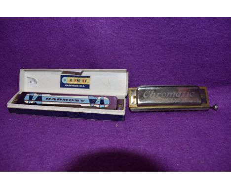 A boxed vintage Harmony harmonica and Koch-Harmonica in C.