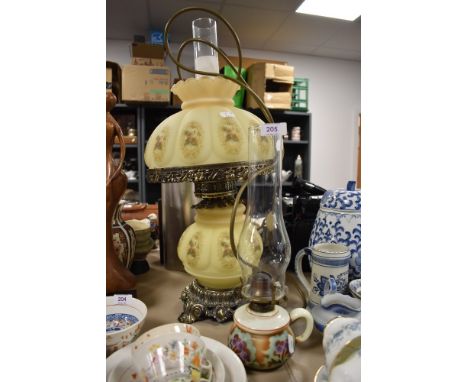 An electric light in the form of a Victorian gas lamp and similar oil burner