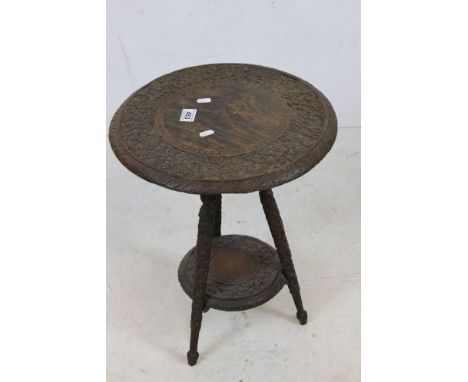 Late 19th / Early 20th century Anglo-Indian Teak Table with foliate carving throughout, the three legs united by an under-she