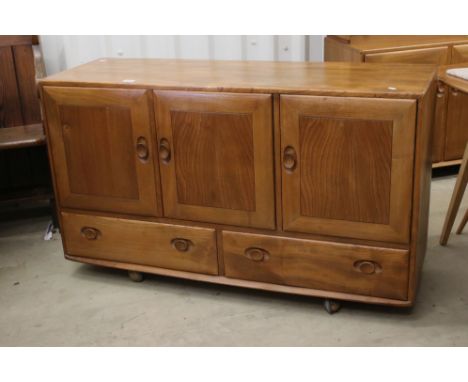 Ercol Windsor Light Elm Sideboard, model 468, comprising three cupboard doors over two drawers, raised on ball castors, 129cm