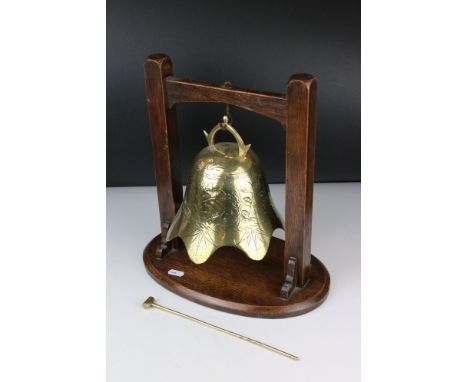 Brass engraved Temple Bell with striker held on a Hardwood Stand, 34cm high 