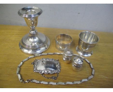 Silver to include a candlestick, napkin ring, salt and pepper pots, decanter label, necklace and egg cup 