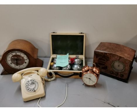 A mixed lot to include a cased set of Jonelle boules, an Art Deco oak mantel clock, a Peter copper alarm clock, a vintage tel