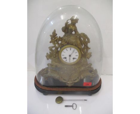 A late 19th century gilt spelter mantel clock, surmounted by a woman under a glass dome 