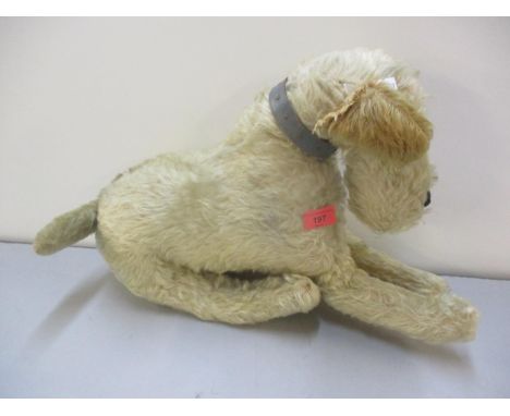 A vintage blonde faux fur dog soft toy with leather collar, straw filled having glass eyes and a black leather nose 